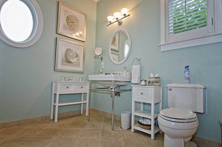 bathroom with aqua walls and white furnishings