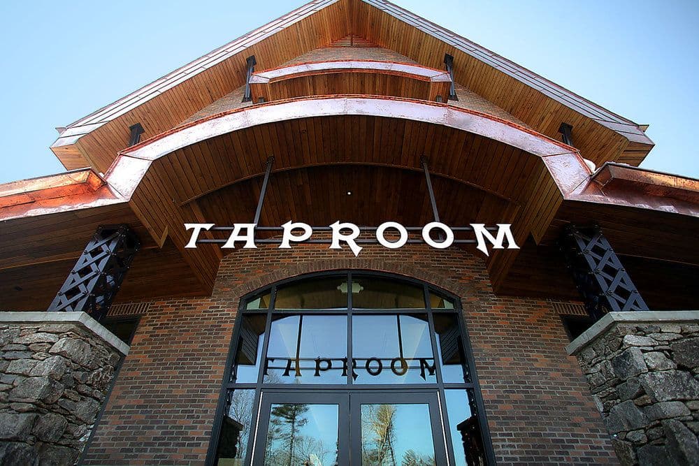 Exterior view of a building featuring a prominent "TAPROOM" sign.