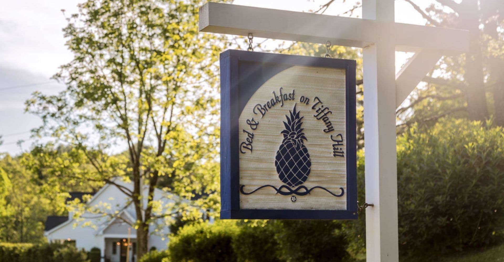 A sign for "Bed & Breakfast on Tiffany Hill" featuring a pineapple design.